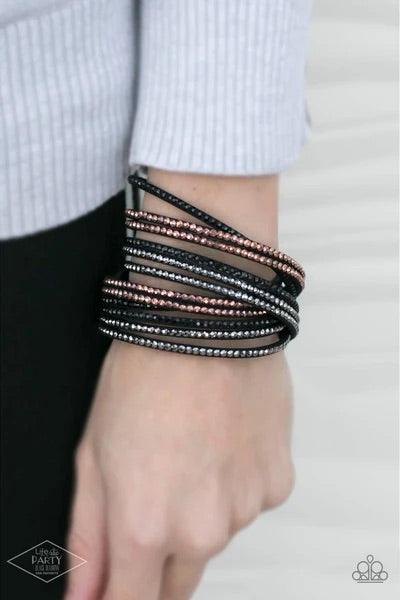 Paparazzi Accessories Do The Hustle - Black Black suede is spliced into six strands and embellished with rows of black, hematite, and metallic rhinestones brushed in a copper finish for a glitzy combination. The elongated leather band allow for a trendy d