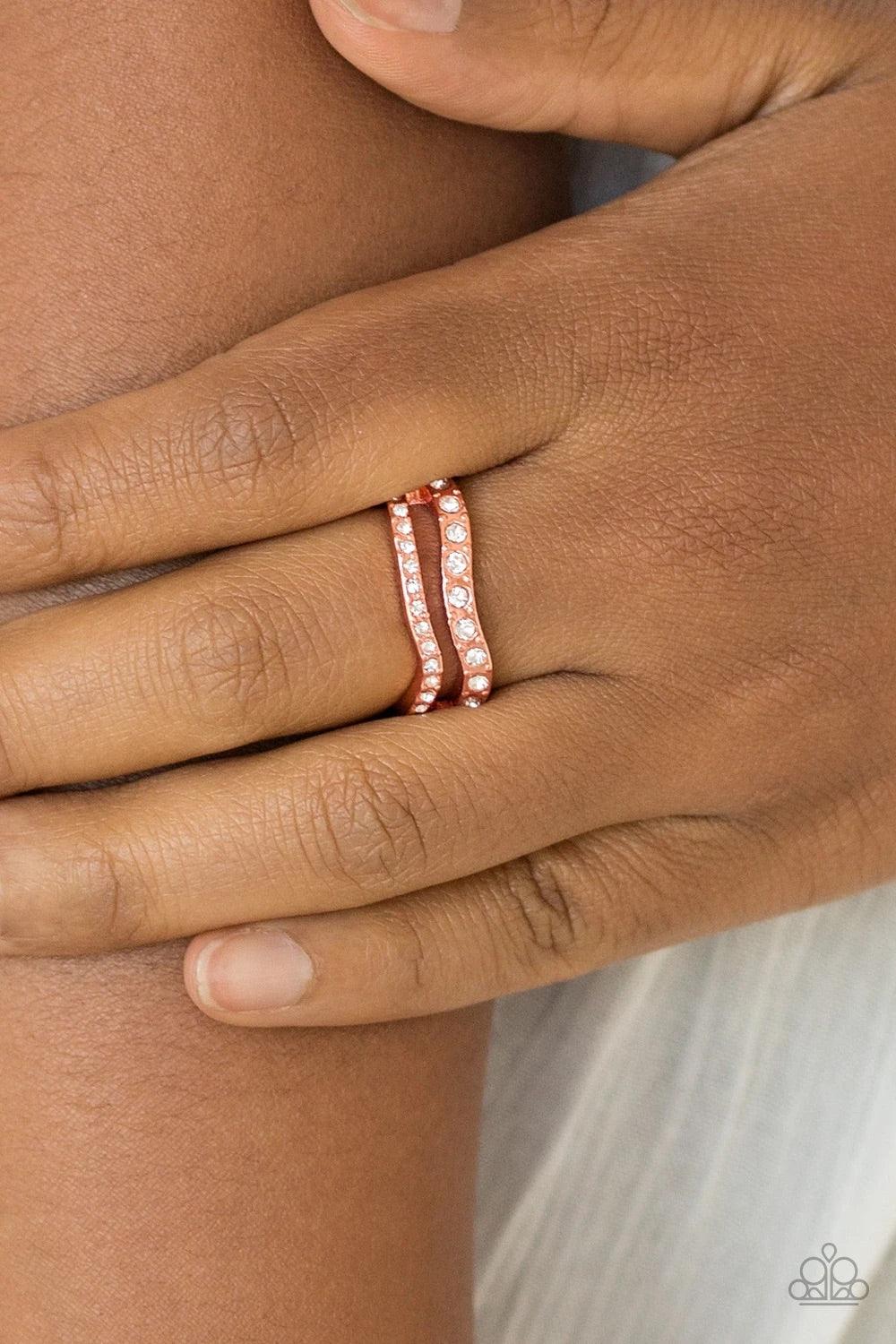 Paparazzi Accessories Elite Squad - Copper Varying in size, glittery white rhinestones are encrusted along waving shiny copper bands for a refined look. Features a dainty stretchy band for a flexible fit. Sold as one individual ring. Jewelry