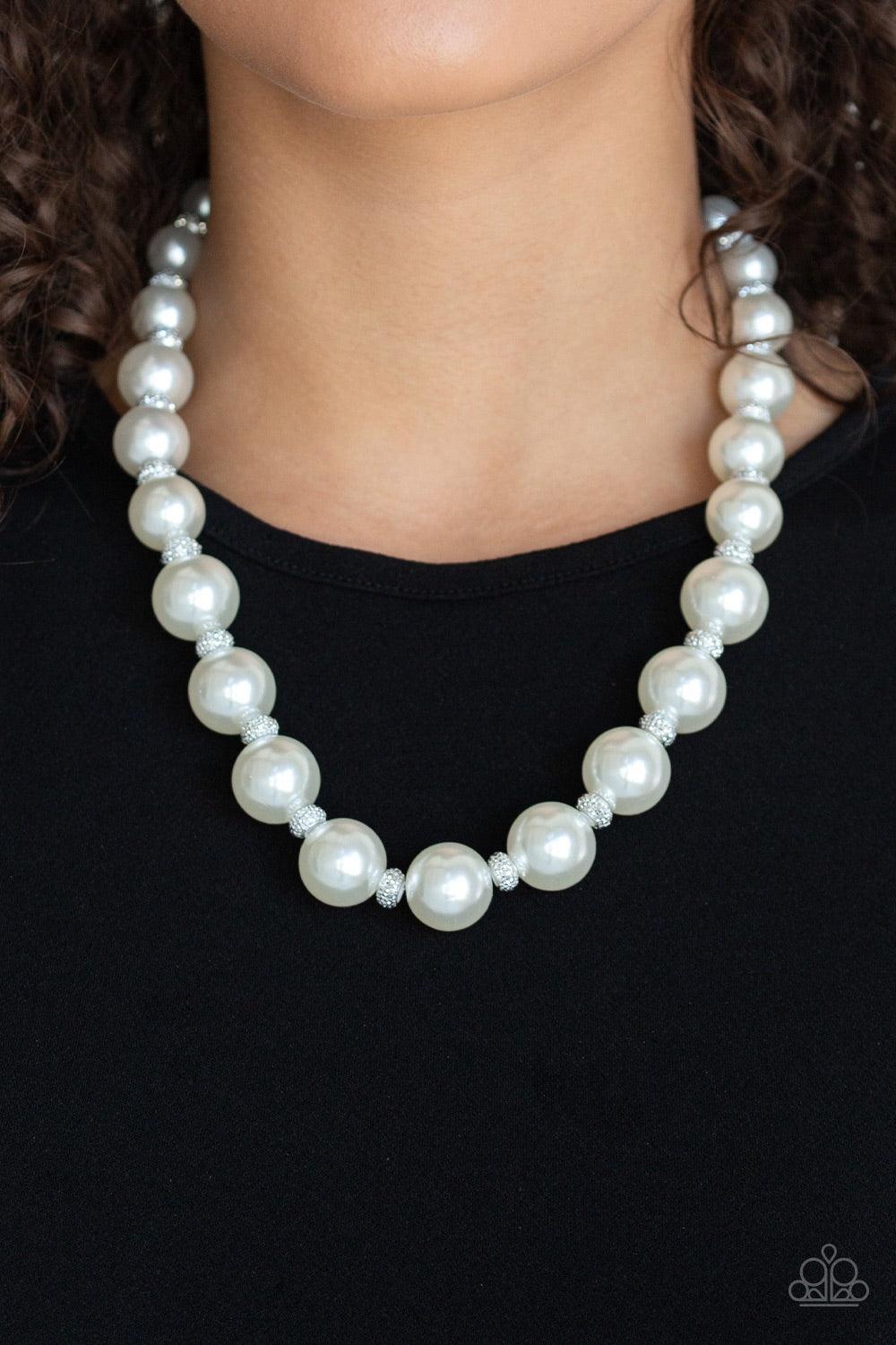 Paparazzi Accessories Uptown Heiress - White Infused with dainty silvery rhinestone encrusted beads, a refined collection of oversized white pearls are threaded along an invisible wire below the collar for a timeless dazzle. Features an adjustable clasp c
