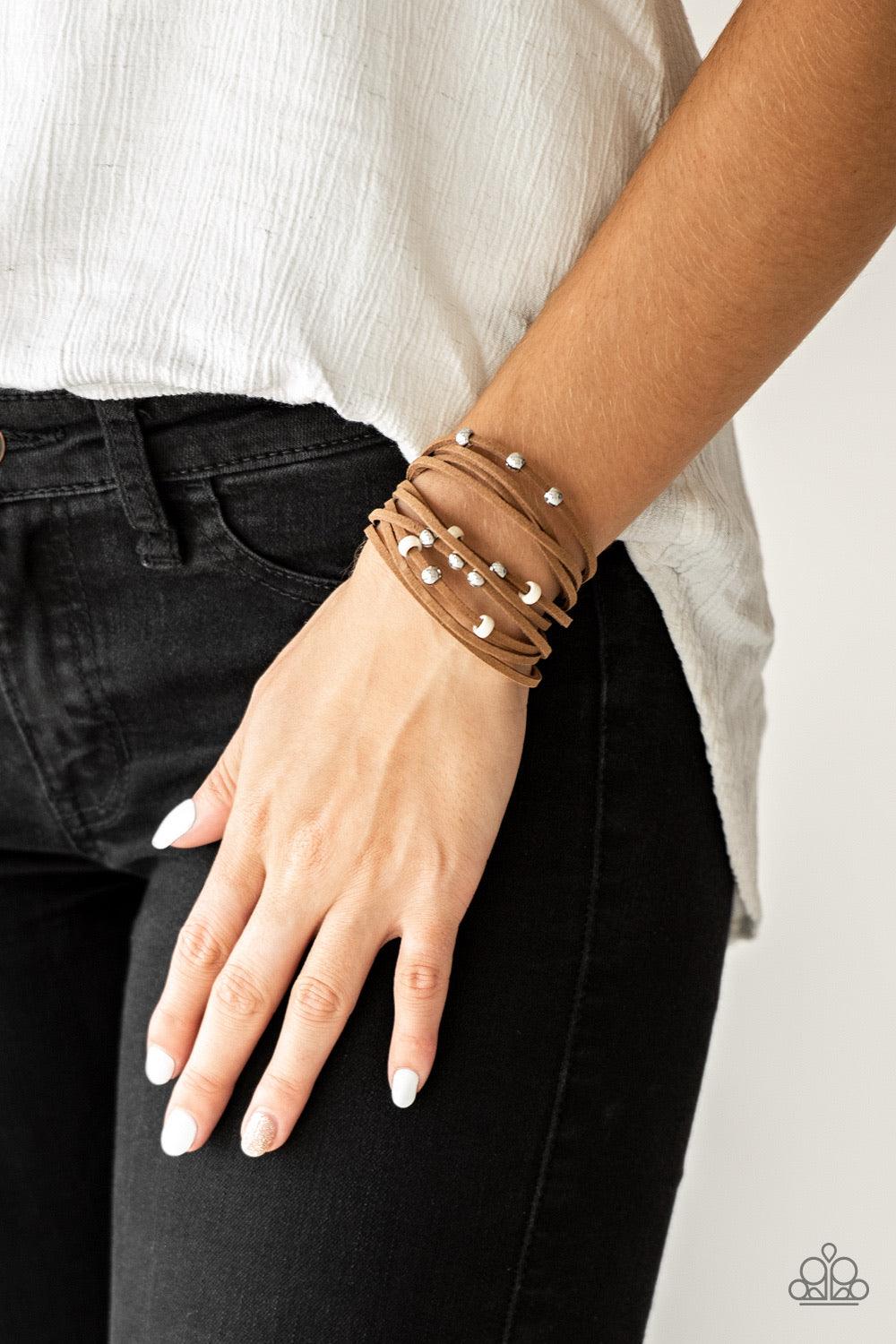 Paparazzi Accessories Colorfully Coachella - White Dainty white wooden beads and classic silver beads are threaded along strands of brown suede, creating colorful layers across the wrist. Features an adjustable clasp closure. Sold as one individual bracel