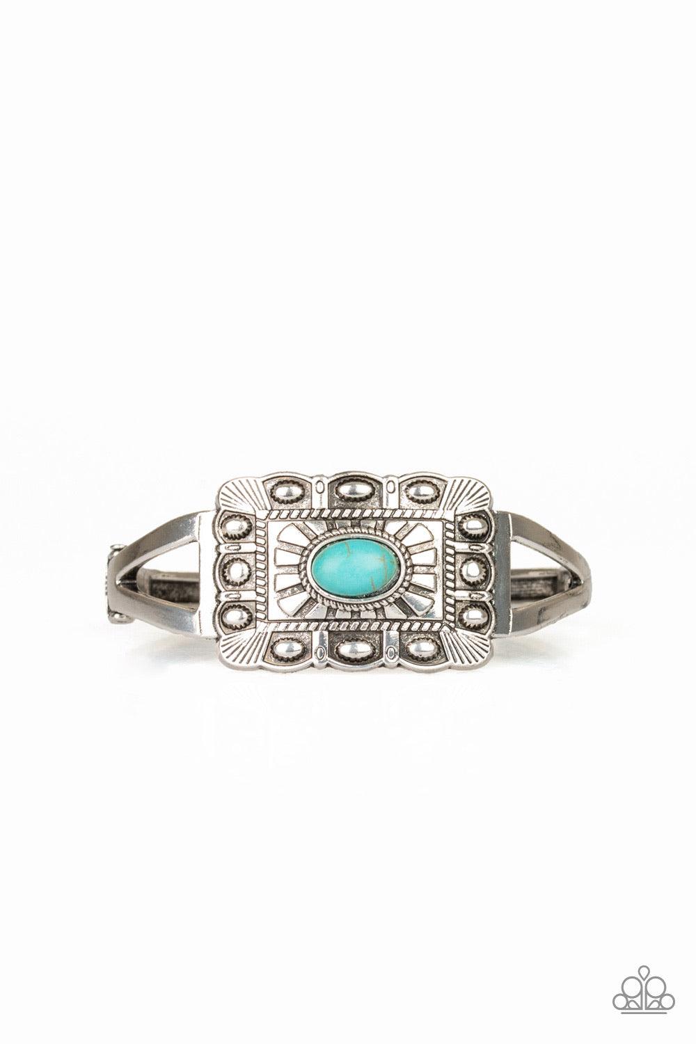 Paparazzi Accessories BIG House On The Prairie - Blue Embossed in sunburst patterns, a rectangular silver frame sits atop a bangle-like cuff for a seasonal flair. A refreshing turquoise stone is pressed into the center for a colorful finish. Features a hi