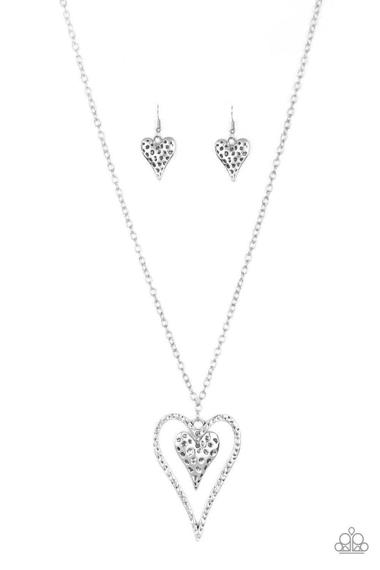 Paparazzi Accessories Hardened Hearts - Silver Hammered in glistening texture, mismatched silver heart frames swing from the bottom of a lengthened silver chain for a whimsical look. Features an adjustable clasp closure. Jewelry