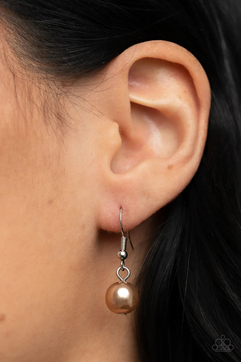 Paparazzi Accessories Sensational Showstopper - Brown Swoon-worthy emerald cut and teardrop rhinestones, accented with bubbly brown pearl beads, coalesce into stunning asymmetrical frames. A trio of elegant brown oval pearl beads alternates with the asymm