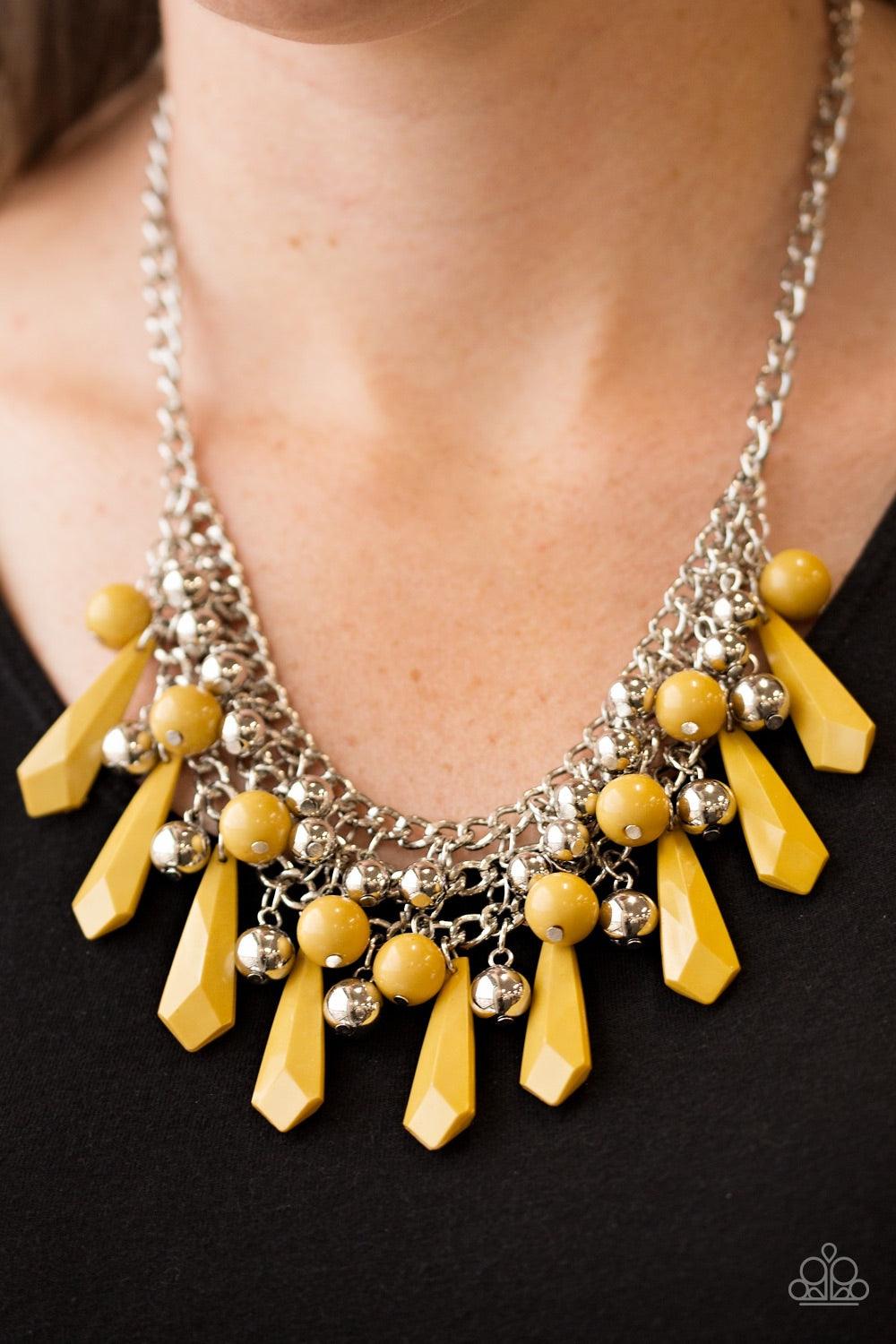 Paparazzi Accessories Diva Dynamics - Yellow Rows of shimmery silver chain interlock below the collar. Tinted in a hearty hue, polished and faceted yellow beads cascade from the interlocked chain, creating a bold fringe. Shiny silver beads are sprinkled b