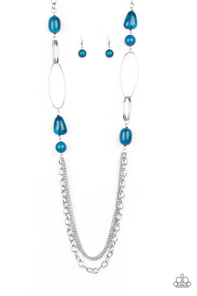 Paparazzi Accessories Pleasant Promenade - Blue Featuring polished and cloudy faux rock finishes, blue beads link with bold silver hoops. The whimsical compilation gives way to layers of mismatched silver chains for a seasonal finish. Features an adjustab
