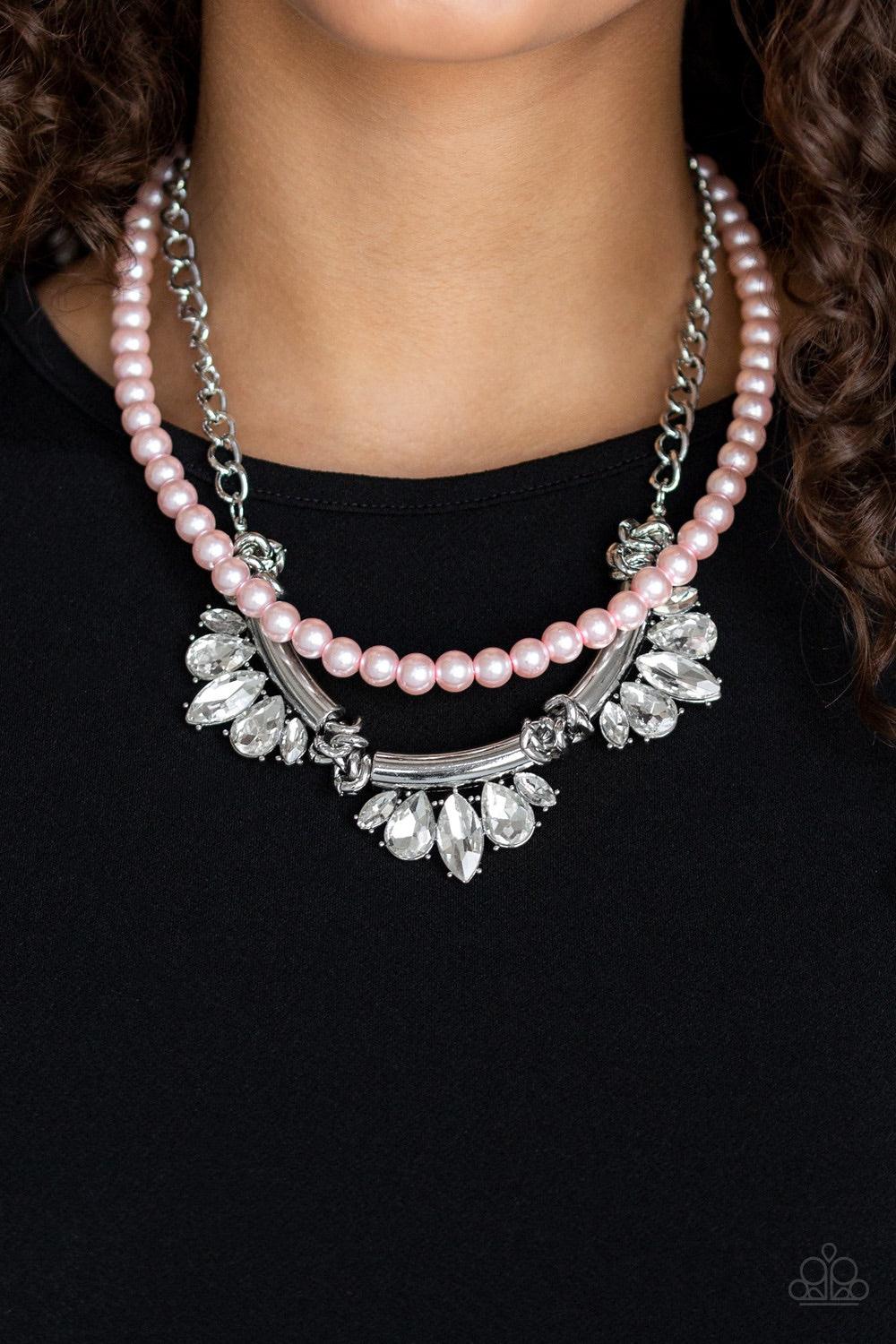 Paparazzi Accessories Bow Before The Queen - Pink A classic strand of pink pearls and dramatic silvery chain drape below the collar. Infused with heavy metal accents, teardrop and marquise cut white rhinestone frames connect into a show-stopping fringe. F