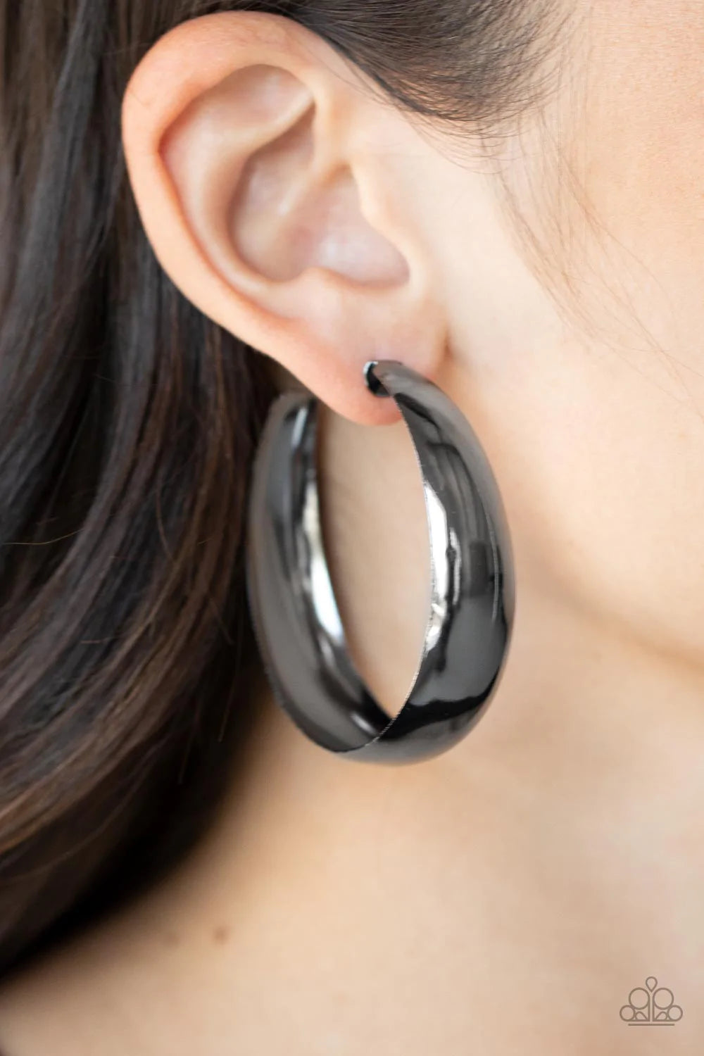 Paparazzi Accessories Flat Out Flawless - Black An oversized flat gunmetal hoop curls around the ear for a fabulously flawless fashion. Earring attaches to a standard post fitting. Hoop measures approximately 2" in diameter. Sold as one pair of hoop earri