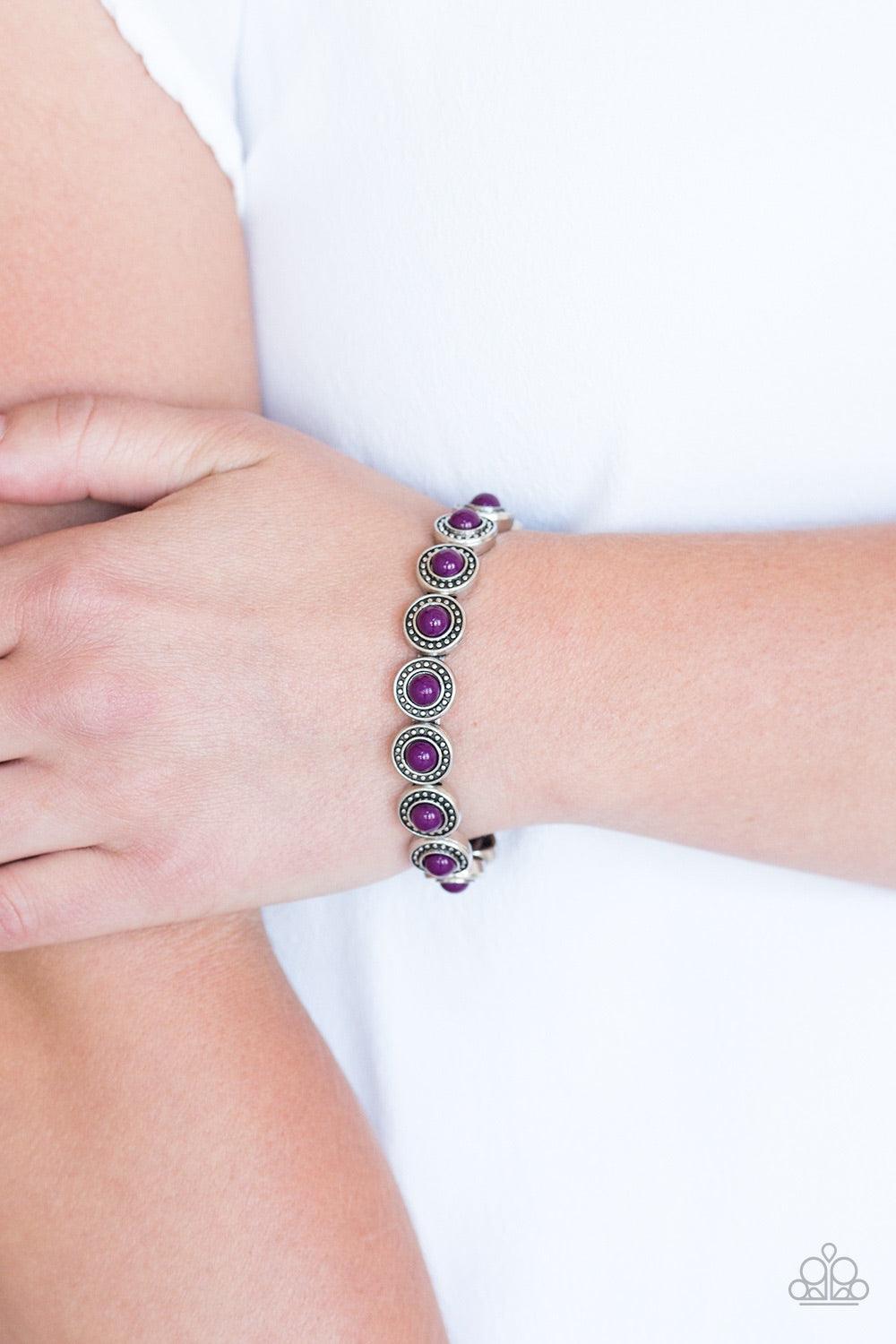 Paparazzi Accessories Globetrotter Goals - Purple Dotted with vivacious purple beaded centers, studded silver frames are threaded along stretchy elastic bands and linked around the wrist for a whimsical look. Jewelry