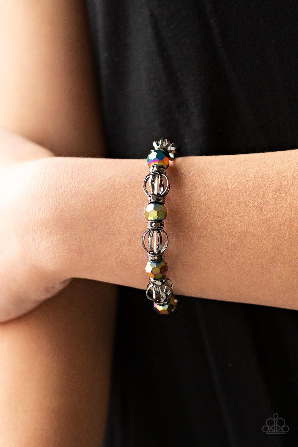 Paparazzi Accessories Metro Squad - Multi A collection of airy gunmetal beads, faceted rainbow metallic beads, and hematite rhinestone encrusted rings are threaded along a stretchy band around the wrist for a glamorous look Jewelry