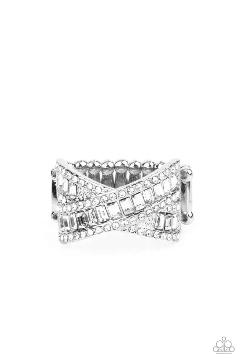 Paparazzi Accessories Status Update - White Two rows of glittering emerald cut white rhinestones crisscross across the finger inside silver frames lined with dainty white rhinestones resulting in a glamorously modern finish. Features a stretchy band for a