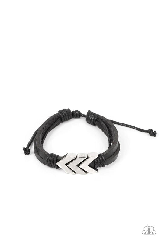 Paparazzi Accessories Arrow Pharaoh - Black A rustic silver chevron-like arrow centerpiece is knotted in place along strips of black leather bands, creating an urban statement around the wrist. Features an adjustable sliding knot closure. Sold as one indi