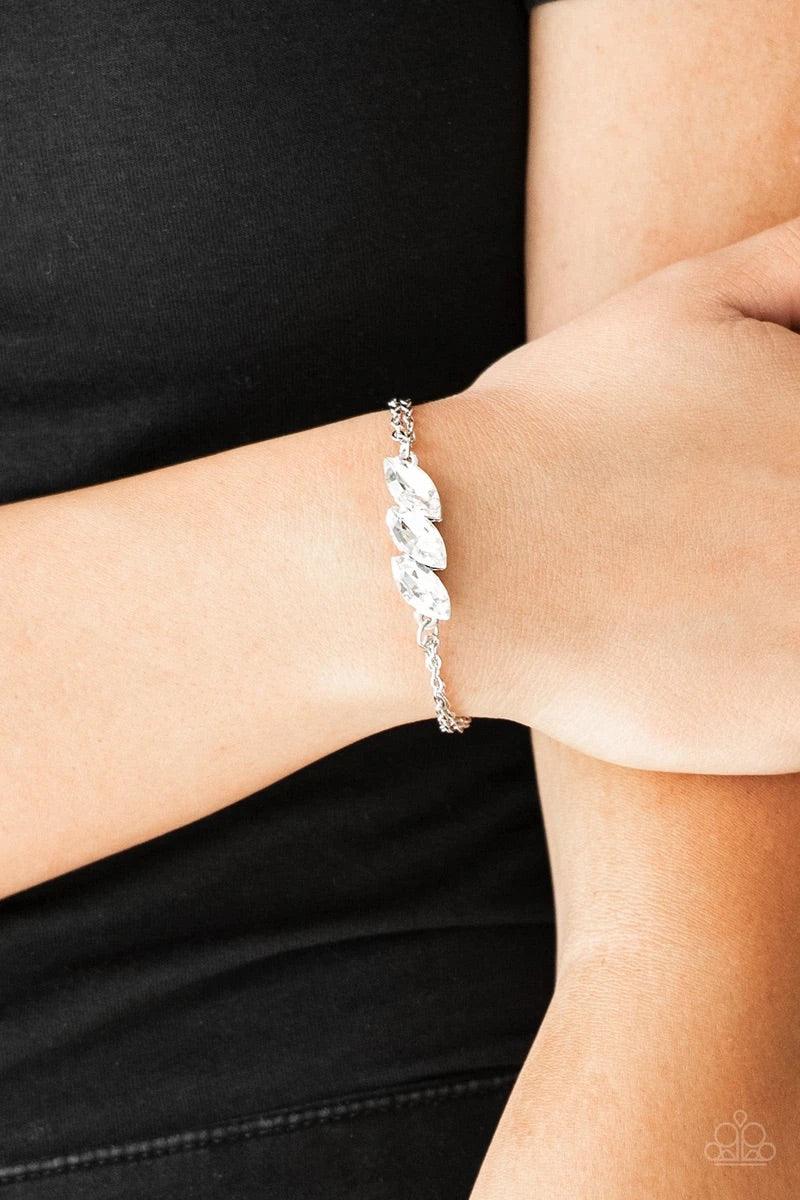 Paparazzi Accessories Pretty Priceless - White Featuring regal marquise-cuts, a trio of glittery white rhinestones join across the center of the wrist for a timeless look. Features an adjustable clasp closure. Sold as one individual bracelet. Jewelry