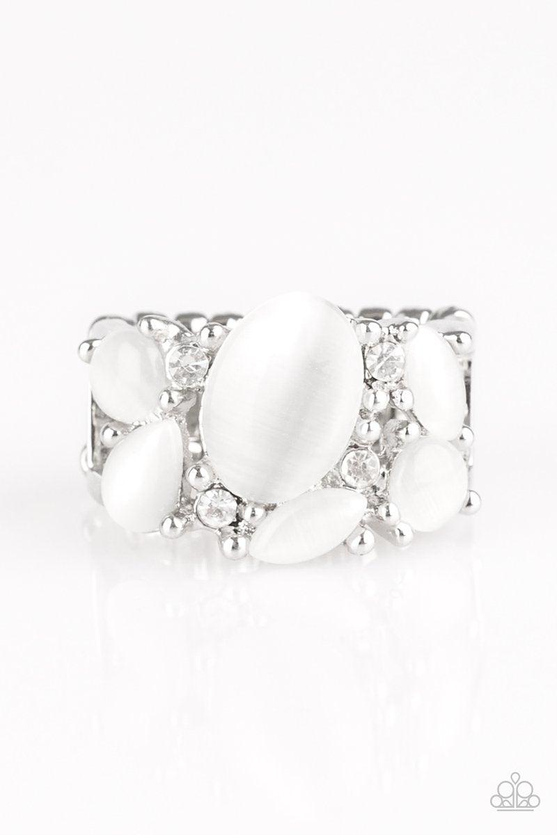 Paparazzi Accessories Modern Moonwalk - White Glittery white rhinestones and glowing white moonstones are sprinkled across the finger, coalescing into a whimsical band. Features a stretchy band for a flexible fit. Sold as one individual ring. Jewelry