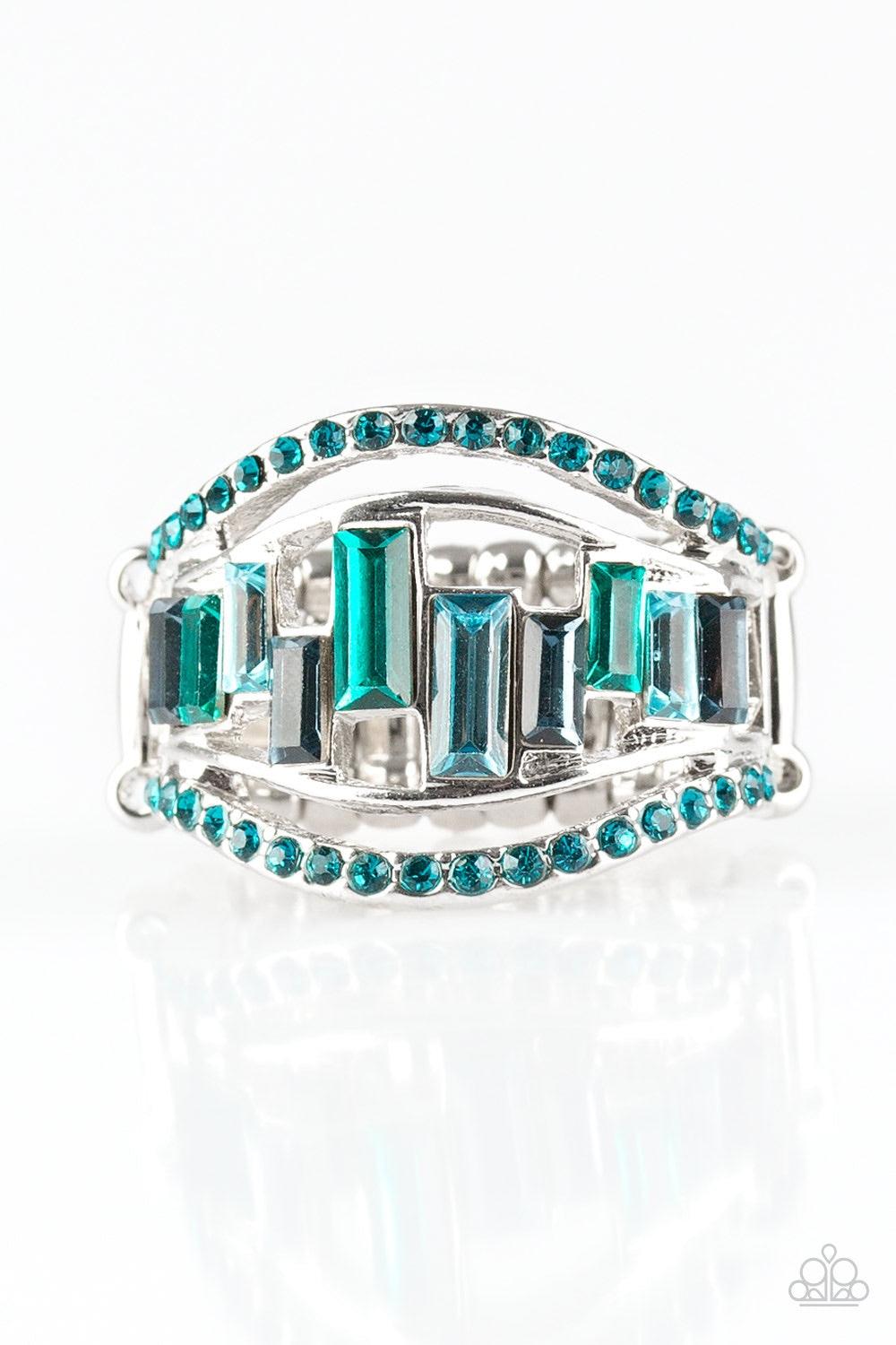 Paparazzi Accessories Treasure Chest Charm - Blue Blue rhinestone encrusted bands flank a row of emerald cut glass beads in shades of blue for a regal look. Features a stretchy band for a flexible fit. Jewelry