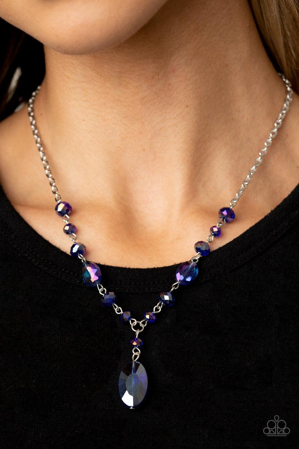 Paparazzi Accessories Fashionista Week - Blue Featuring an iridescent shimmer, an oval blue crystal-like bead swings from the bottom of a matching crystal-beaded chain, creating an elegantly extended pendant below the collar. Features an adjustable clasp
