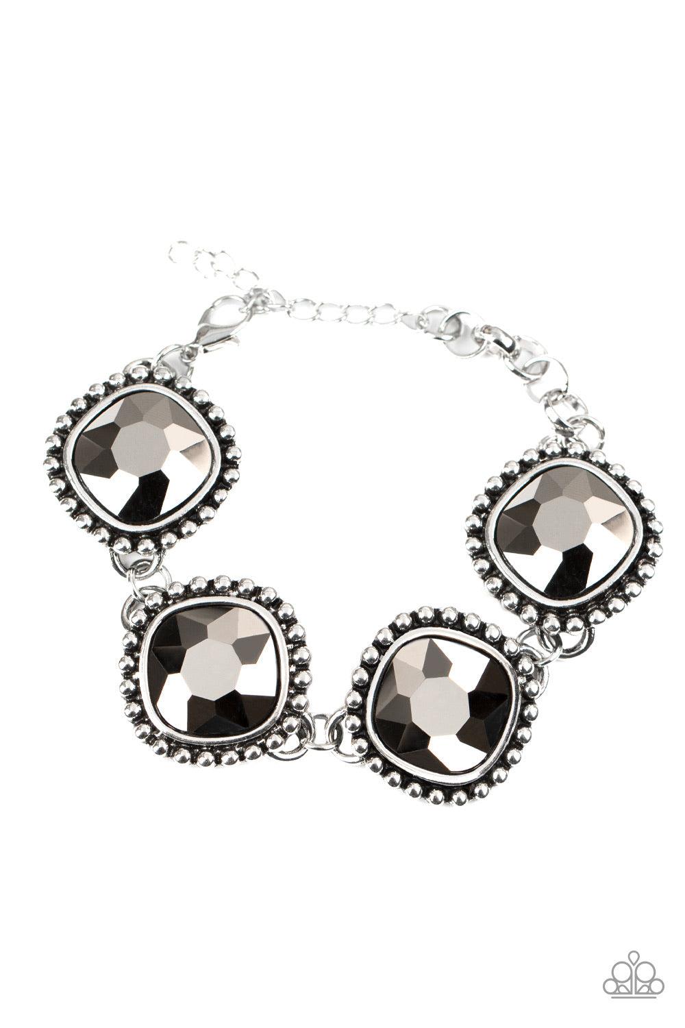 Paparazzi Accessories Megawatt - Silver Featuring dramatically studded silver frames, an exaggerated display of oversized hematite rhinestone encrusted frames delicately link around the wrist for a blinding look. Features an adjustable clasp closure. Jewe