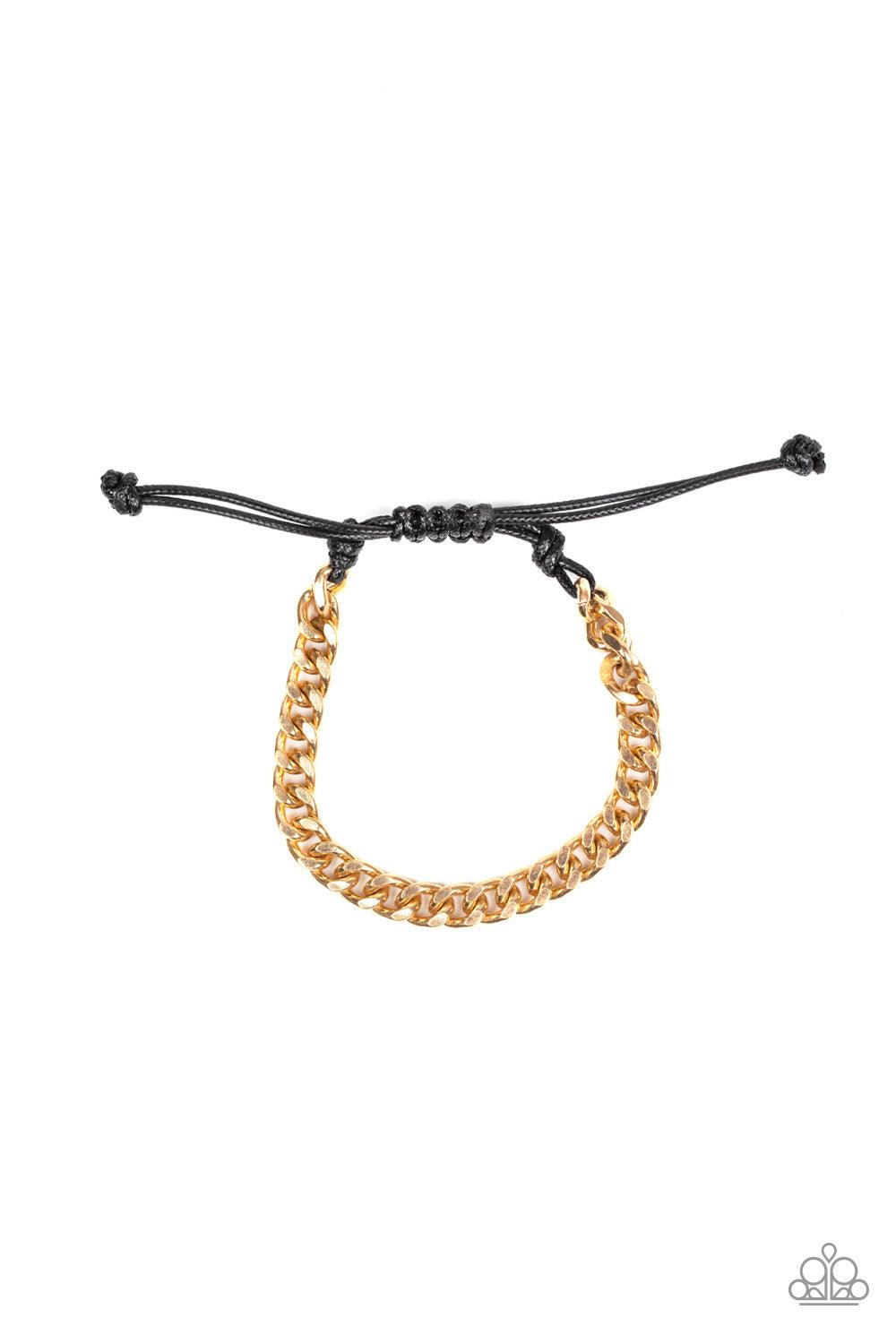 Paparazzi Accessories Rulebreaker - Gold Shiny black cording knots around the ends of an ornate gold beveled cable chain that is wrapped across the top of the wrist for a versatile look. Features an adjustable sliding knot closure. Jewelry