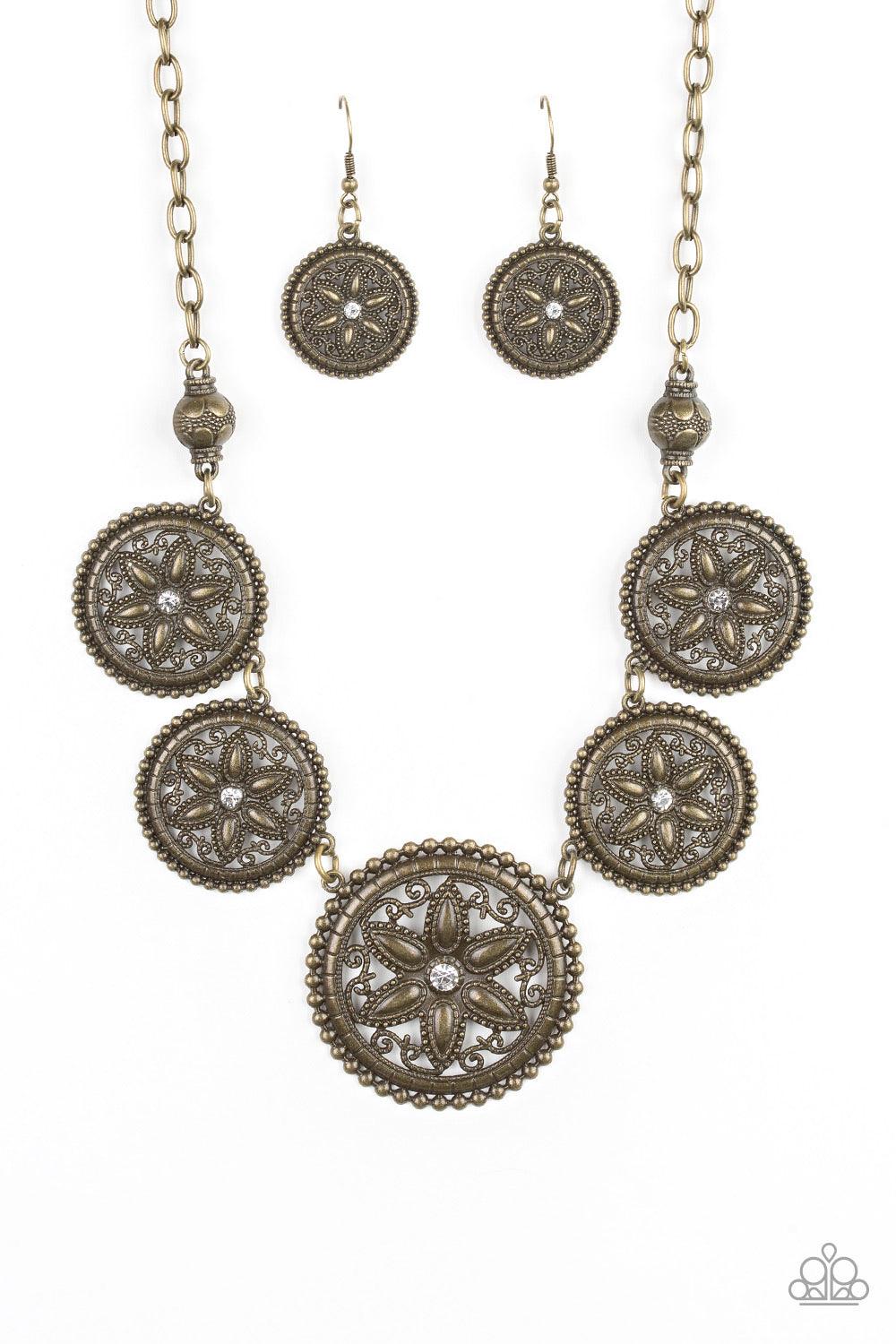 Paparazzi Accessories Written In The STAR LILLIES - Brass Dotted with glittery rhinestone centers, floral brass frames gradually increase in size as they link below the collar for a whimsical look. Features an adjustable clasp closure. Jewelry