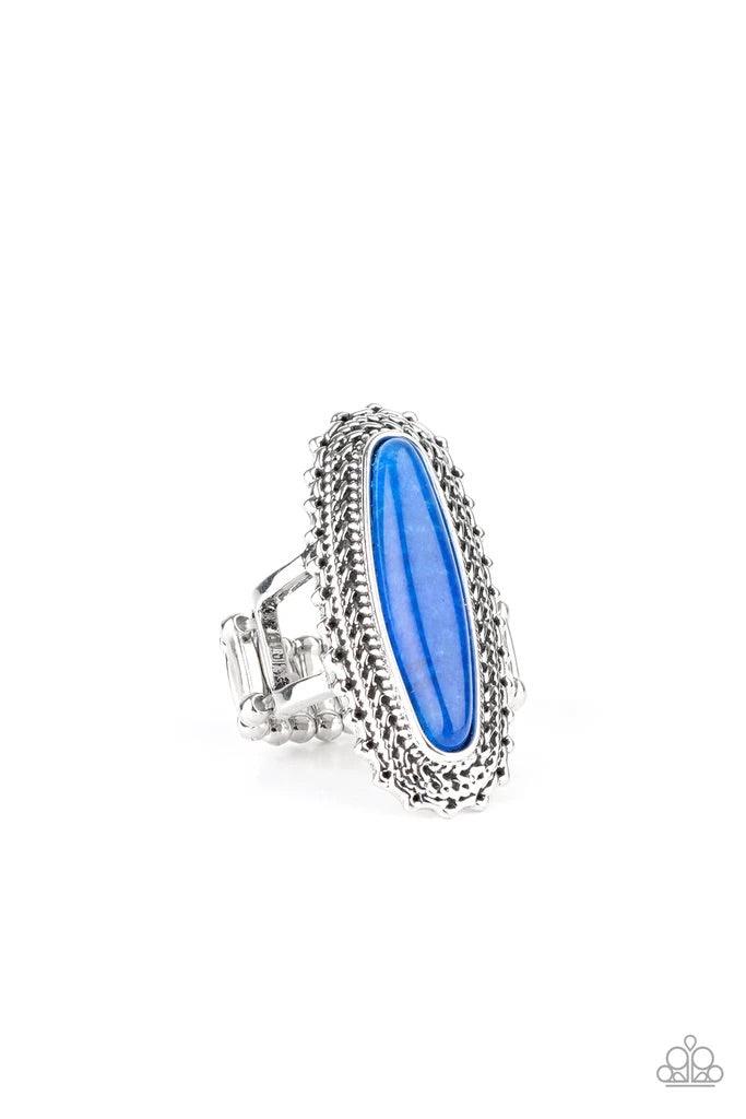 Paparazzi Accessories Mystical Mecca - Blue An oblong blue stone adorns the center of an elongated silver frame featuring mismatched silver textures for a bold artisan look. Features a stretchy band for a flexible fit. Sold as one individual ring. Jewelry