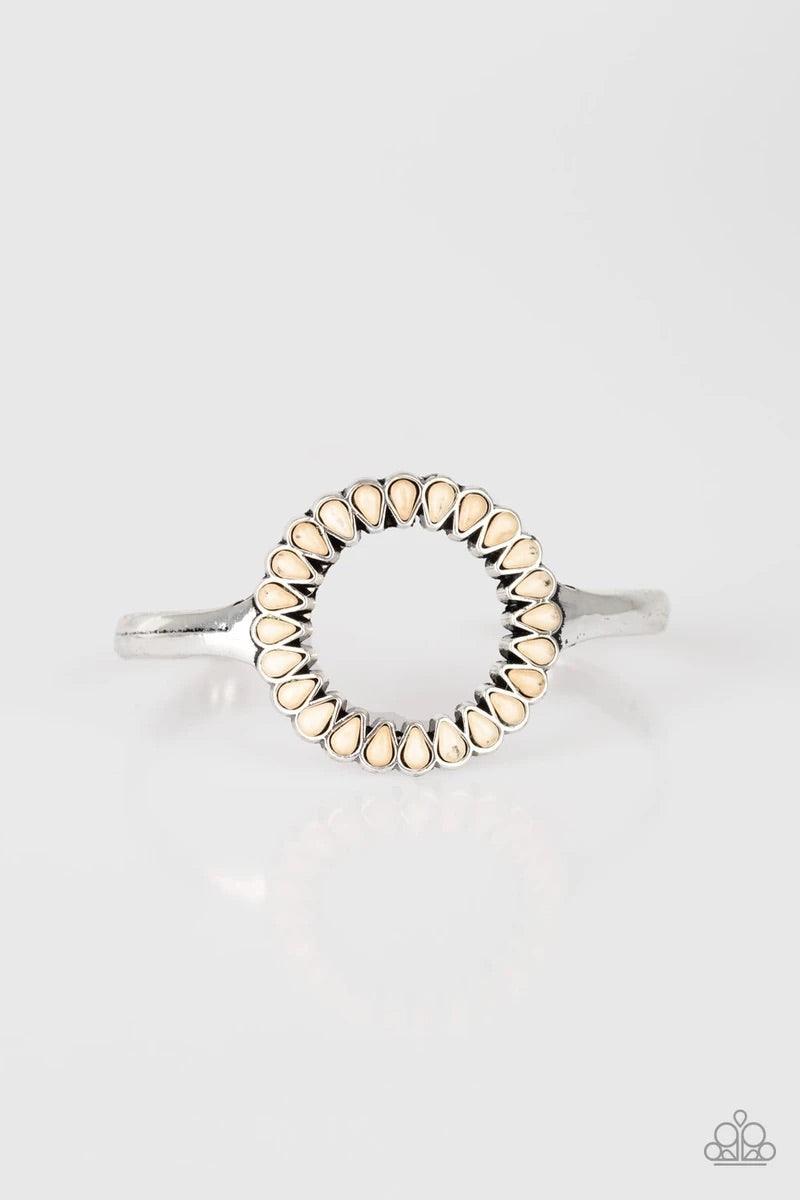 Paparazzi Accessories Divinely Desert - White Chiseled into tranquil teardrops, refreshing white stones spin around the center of an antiqued silver cuff for a seasonal look. Sold as one individual bracelet. Jewelry