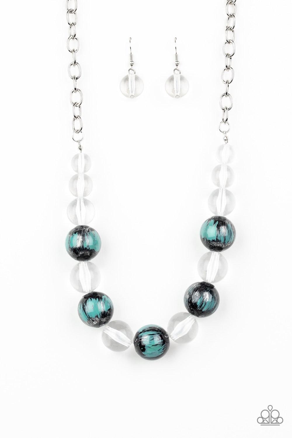 Paparazzi Accessories Torrid Tide - Blue A collection of shiny black and glassy clear beads are threaded along an invisible wire below the collar. The black beads are splashed in hints of refreshing blue and shiny metallic paint for a colorful finish. Fea