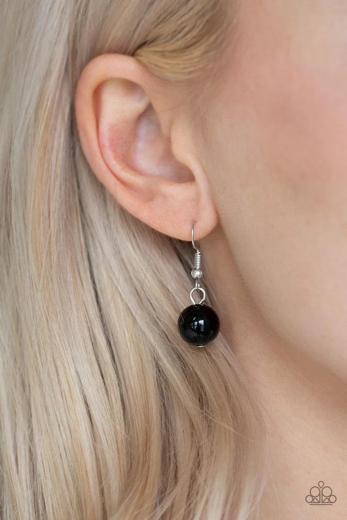 Paparazzi Accessories Hollywood HAUTE Spot - Black A collection of oversized shiny black, silver rings, and asymmetrical silver beads are threaded along an invisible wire below the collar. White rhinestone encrusted rings are sprinkled between the refined