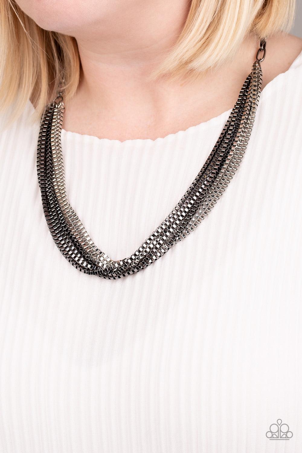 Paparazzi Accessories Beat Box Queen - Black Attached to a thick gunmetal chain, a collision of silver and gunmetal box chains layer below the collar for an edgy mix. Features an adjustable clasp closure. Sold as one individual necklace. Includes one pair