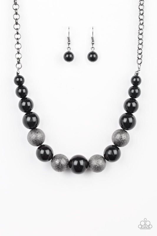 Paparazzi Accessories Color Me CEO - Black Dusted in glitter, sparkling gunmetal and shiny black beads are threaded along an invisible wire below the collar for a glamorous look. Features an adjustable clasp closure. Sold as one individual necklace. Inclu