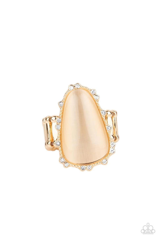 Paparazzi Accessories Newport Nouveau - Gold A tranquil champagne cat's eye stone is encased in a delicately dotted shimmery gold frame. Dainty sparkly rhinestones surround the oversized stone creating an elegant centerpiece atop the finger. Features a st