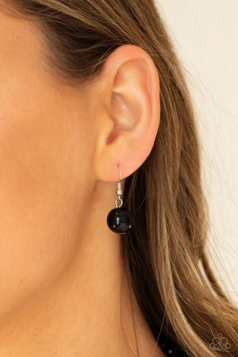 Paparazzi Accessories All Dolled UPSCALE - Black Dainty black beads and sparkly white crystal-like beads cluster between oversized black beads that are threaded along an invisible wire below the collar, creating a stunning centerpiece. Features an adjusta
