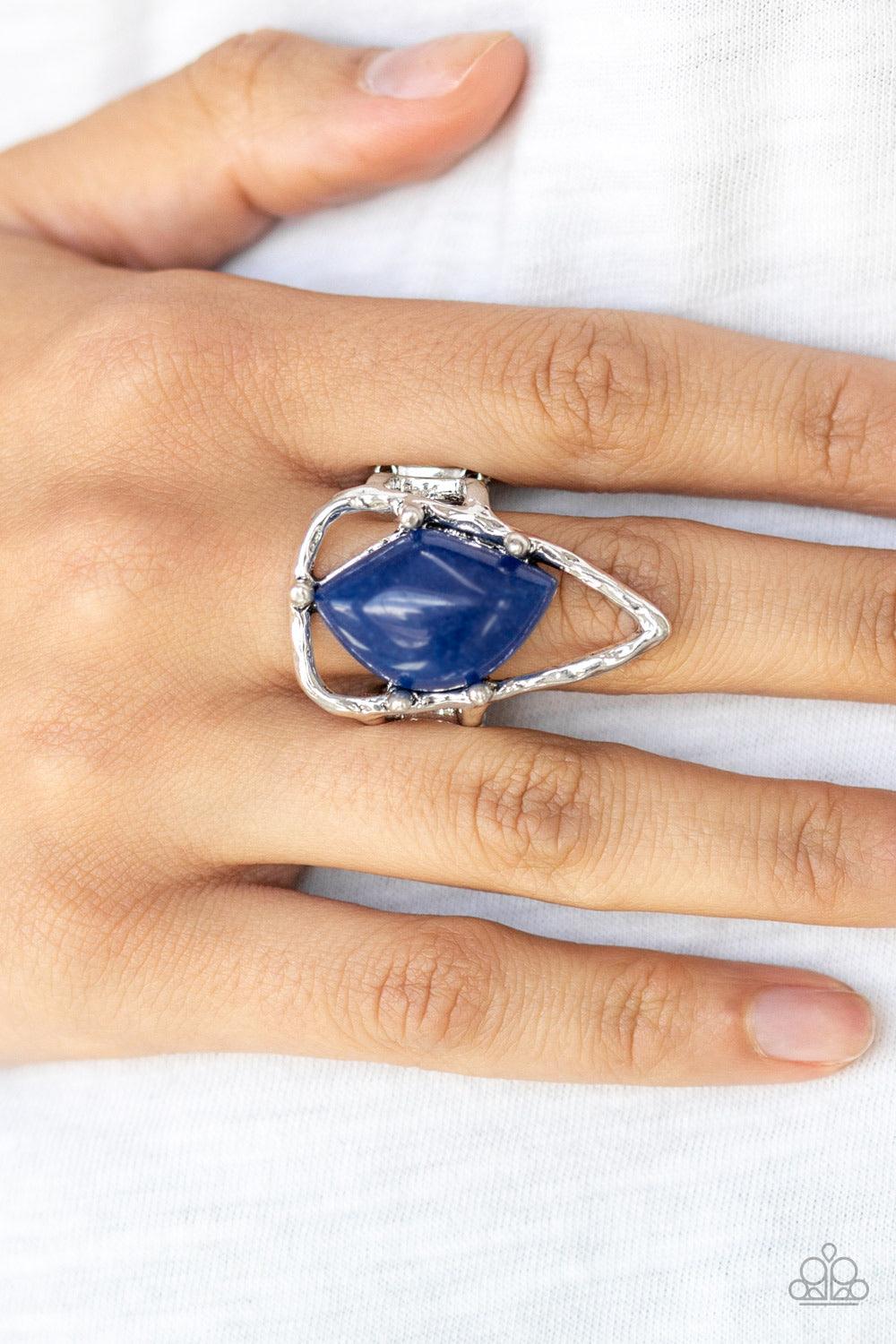 Paparazzi Accessories Get The Point - Blue An abstract blue stone is nestled inside a hammered silver triangle, creating an artisan inspired frame atop the finger. Features a stretchy band for a flexible fit. Jewelry