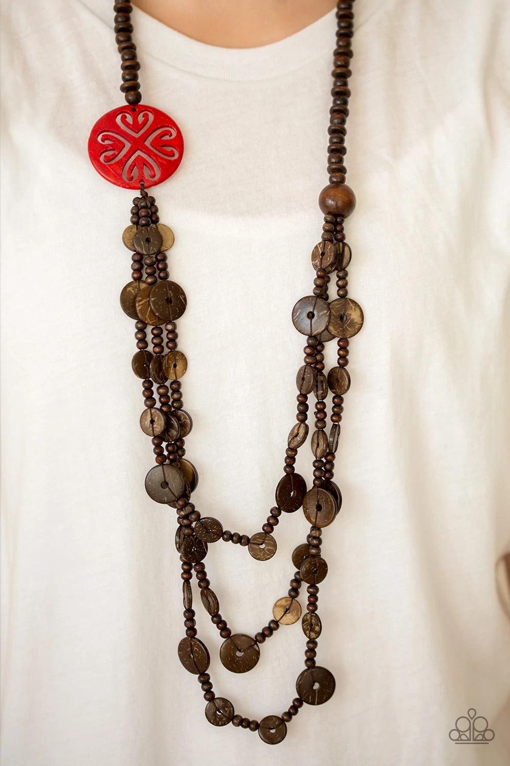 Paparazzi Accessories Jungle Jive - Red Mismatched brown wooden beads are threaded along a shiny brown string, creating summery layers across the chest. Featuring a whimsical floral pattern, a dramatic red wooden bead adorns one side for a seasonal finish