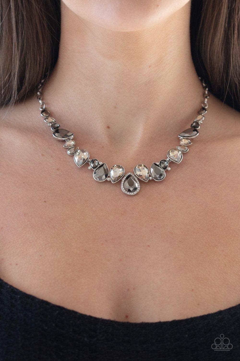 Paparazzi Accessories I Want It All - Silver A sassy combination of smoky, hematite, and metallic finished teardrop gems delicately link into a stunning piece below the collar. Dainty white rhinestones are scattered through the piece for unexpected hints