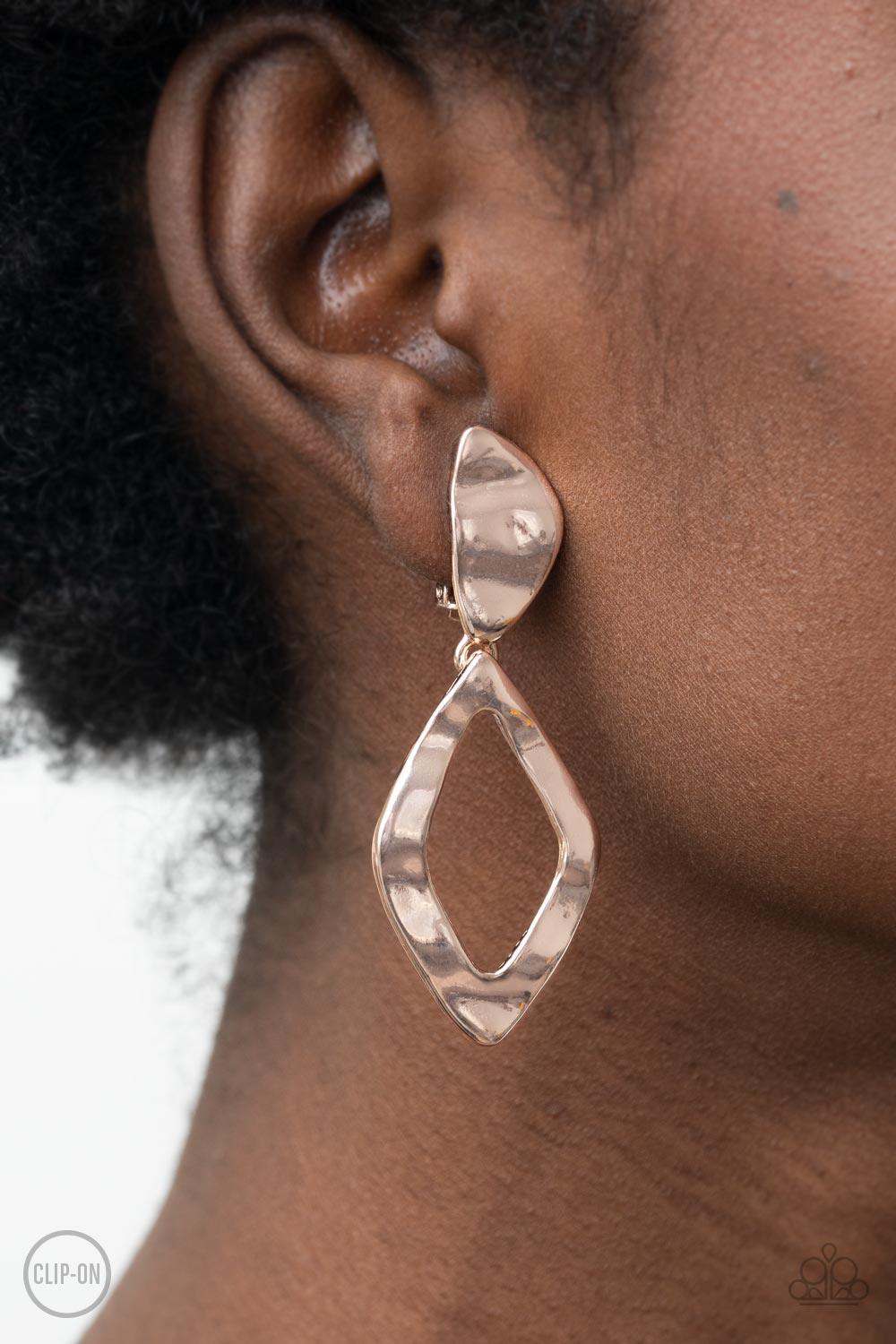 Paparazzi Accessories Industrial Gallery - Rose Gold *Clip-On Rippling with metallic texture, a warped kite-shaped rose gold frame links to the bottom of an asymmetrical frame for an intensely industrial flair. Earring attaches to a standard clip-on fitti