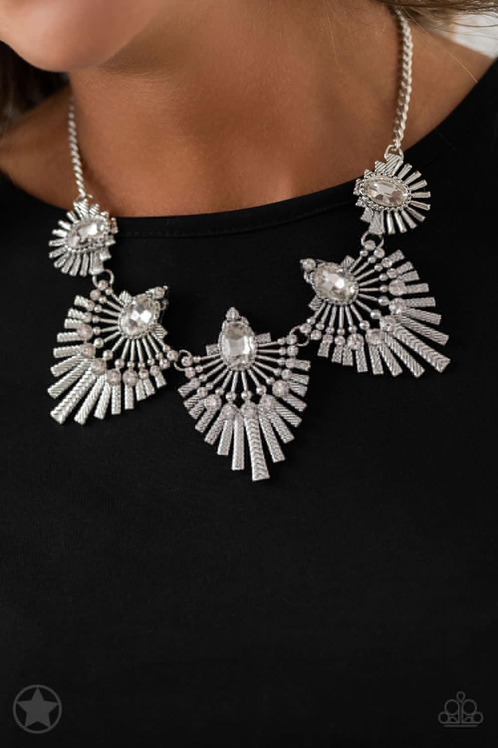 Paparazzi Accessories Miss YOU-niverse - Silver Textured metal bars flare out from a mesmerizing gem, creating a fringe of fanning frames. Sprinkled with matching white rhinestones, the dazzling display falls just below the collar for a sassy finish. Feat