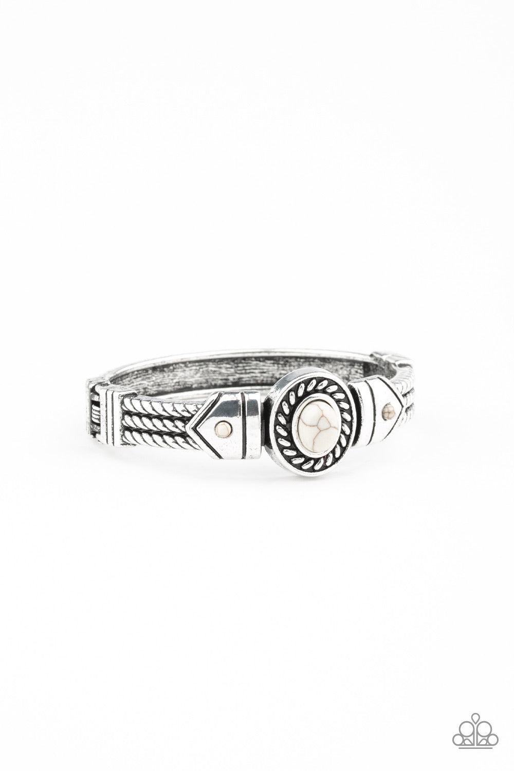 Paparazzi Accessories Tribal Soul ~White Featuring metallic rope-like patterns, an ornate bangle-like cuff curls around the wrist. Refreshing white stones dot the center of the ornate frame for a seasonal flair. Features a hinged closure. Jewelry