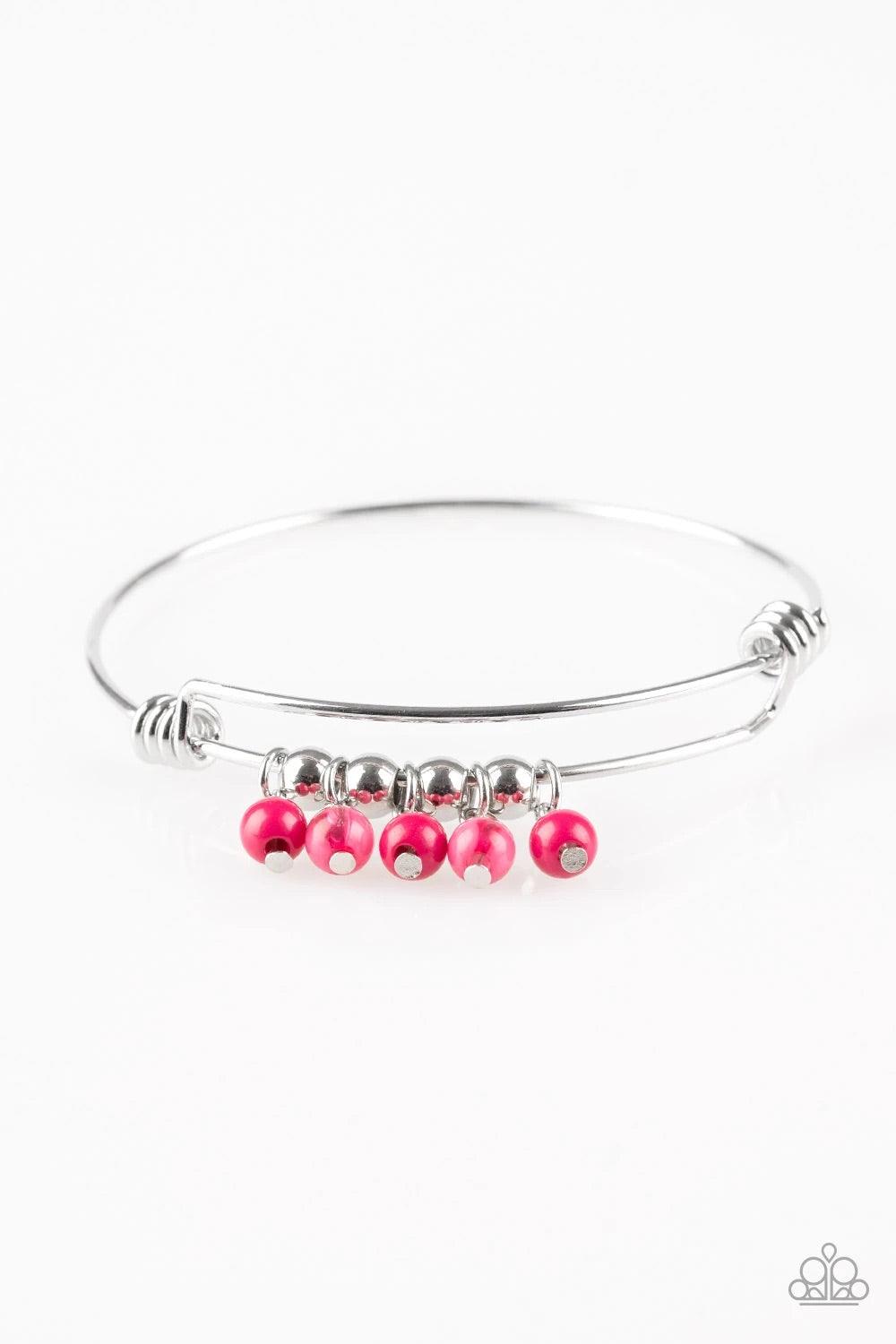 Paparazzi Accessories All Roads Lead to ROAM - Pink Silver wire coils around the wrist, creating an adjustable-like bangle. Glassy pink beads slide between two wire wrap fittings, creating colorful accents along the wrist. Sold as one individual bracelet.