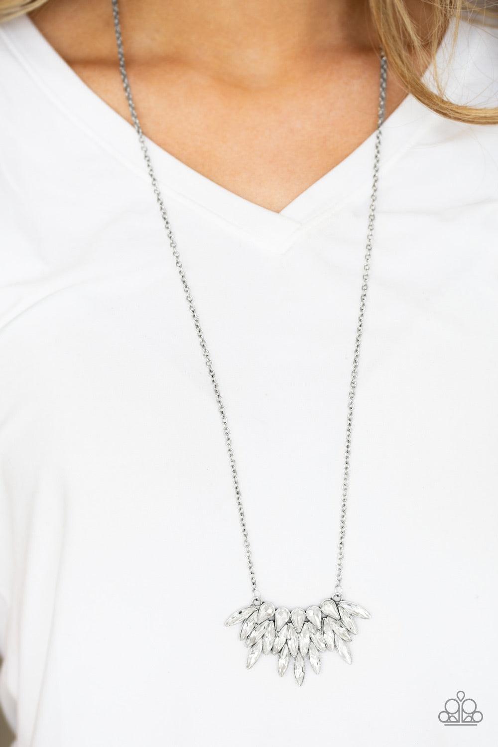 Paparazzi Accessories Crowning Moment - White Featuring regal teardrop and marquise style cuts, glittery white rhinestones fan from the bottom of a lengthened silver chain for a dramatic look. Features an adjustable clasp closure. Sold as one individual n