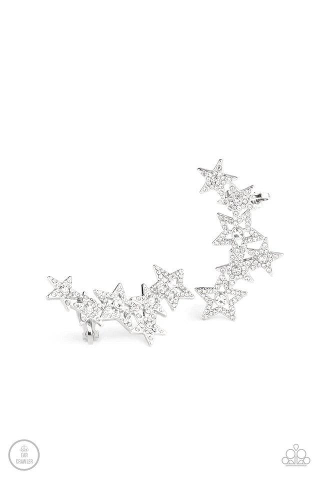 Paparazzi Accessories Star-Spangled Shimmer - White A stellar display of white rhinestone encrusted stars curve up the ear, coalescing into a sparkle-spangled statement piece. Earring attaches to a standard post fitting. Features a clip-on fitting on the