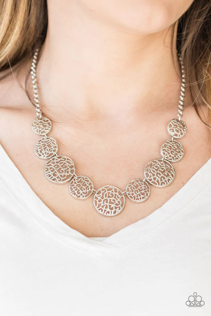 Paparazzi Accessories All The Time In The Whirl - Silver Filled with whirling filigree centers, shiny silver frames link below the collar for a whimsical look. Features an adjustable clasp closure. Sold as one individual necklace. Includes one pair of mat