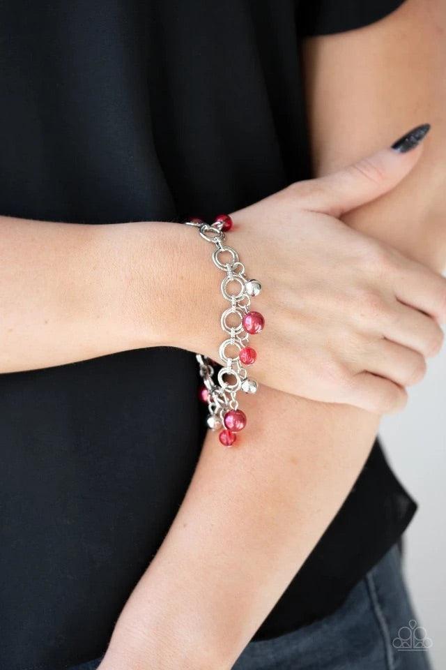 Paparazzi Accessories Fancy Fascination - Red Featuring pearly and glassy finishes, an array of silver and red beads swing from a double-linked silver chain, creating a fancy fringe around the wrist. Features an adjustable clasp closure. Sold as one indiv