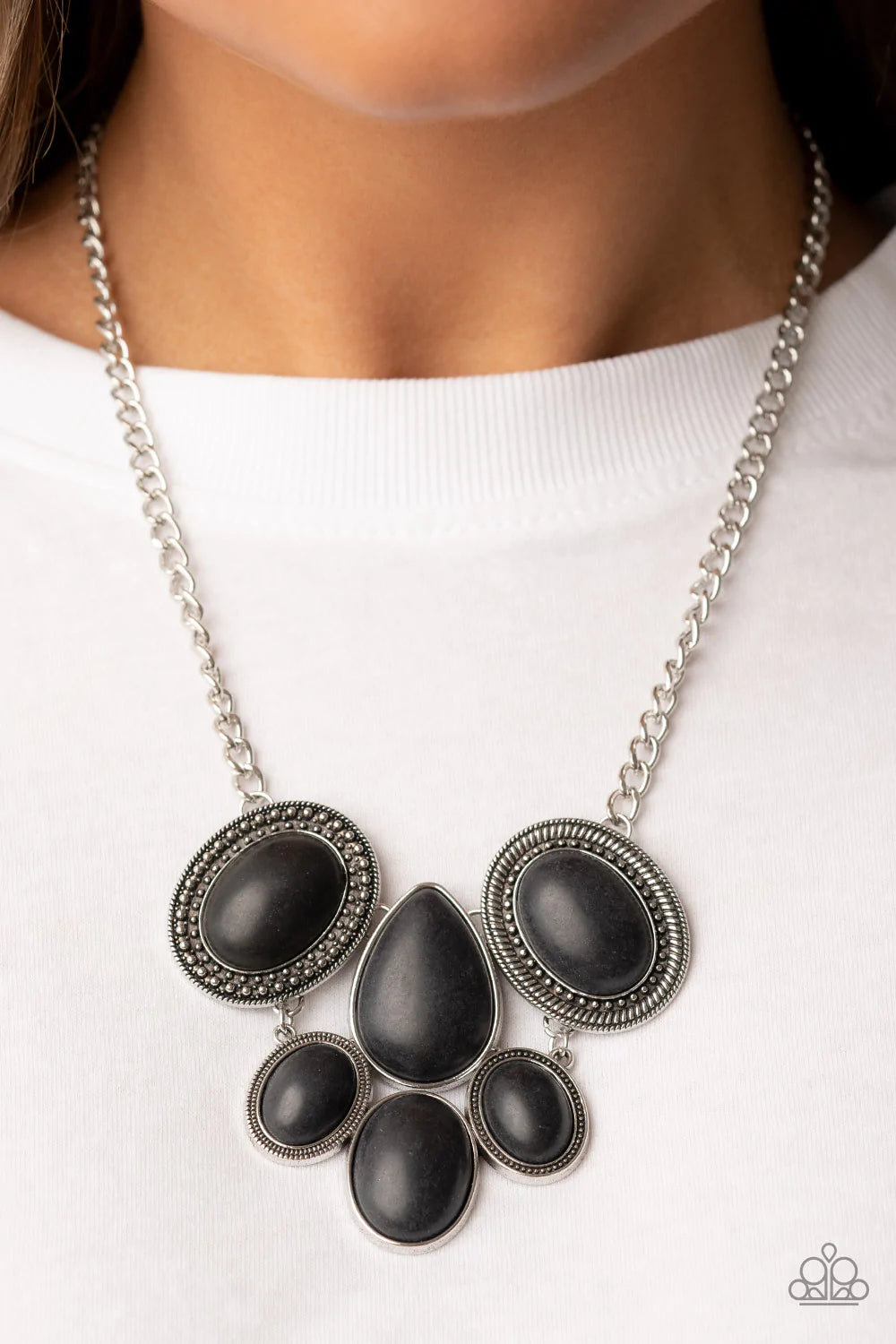 Paparazzi Accessories All Natural Nostalgia - Black Featuring an assortment of studded, textured, and smooth silver frames, a grounding combination of oversized oval and teardrop black stones links into an exaggerated earthy pendant below the collar for a