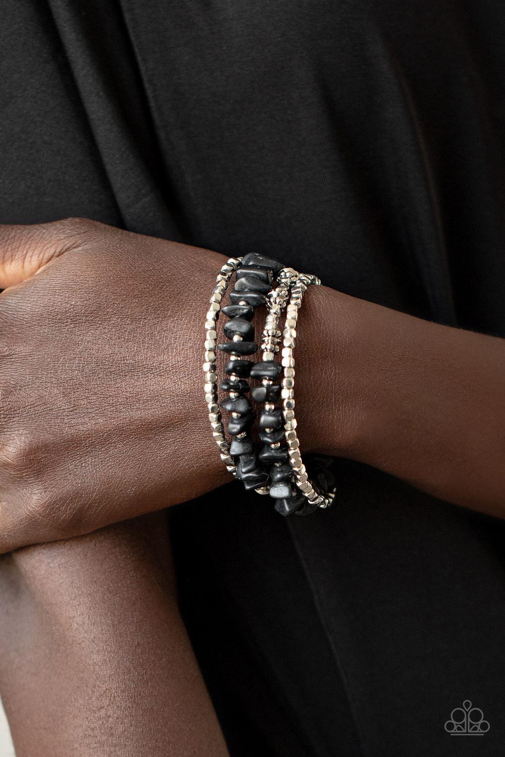 Paparazzi Accessories Rocking Renegade - Black An earthy collision of black stone beads, silver cubes, and decorative silver accents are threaded along a silver wire that coils around the wrist, creating a whimsical infinity wrap bracelet. Sold as one ind