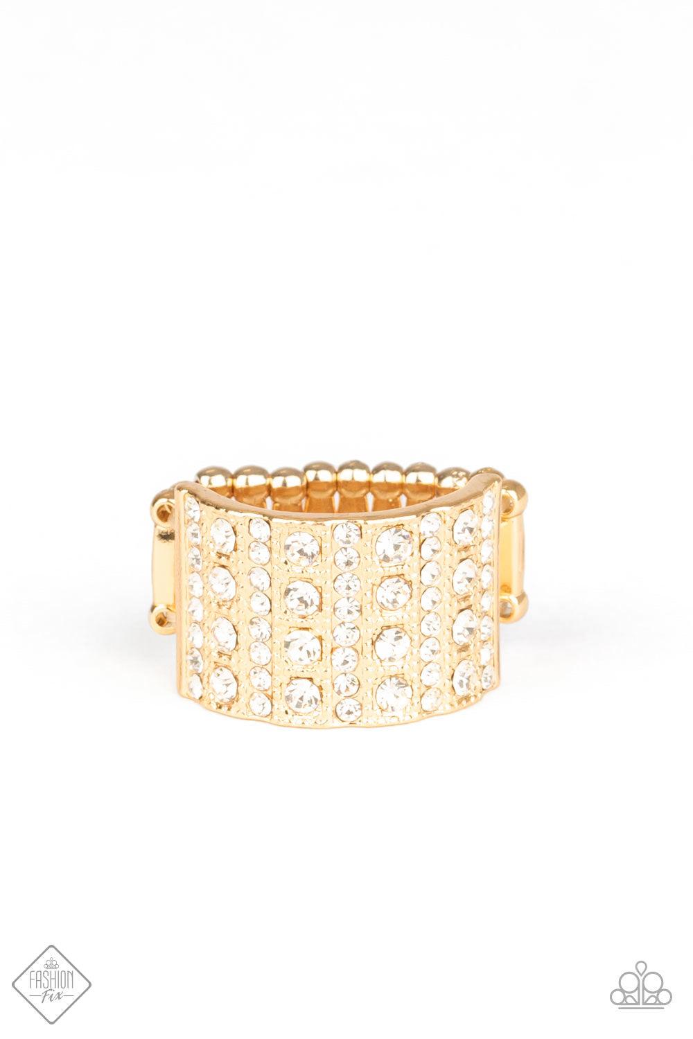 Paparazzi Accessories Diamond Drama - Gold Stacks of dainty and classic white rhinestones are vertically encrusted along a thick gold band, creating a blinding centerpiece. Features a stretchy band for a flexible fit. Jewelry