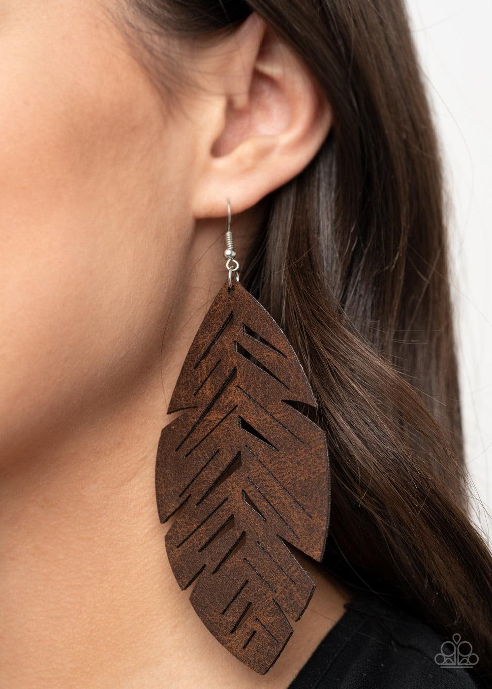 Paparazzi Accessories I Want To Fly - Brown Featuring a rustic finish, a soft piece of brown leather is cut and stenciled into an airy feather frame for a free-spirited look. Earring attaches to a standard fishhook fitting. Sold as one pair of earrings. T