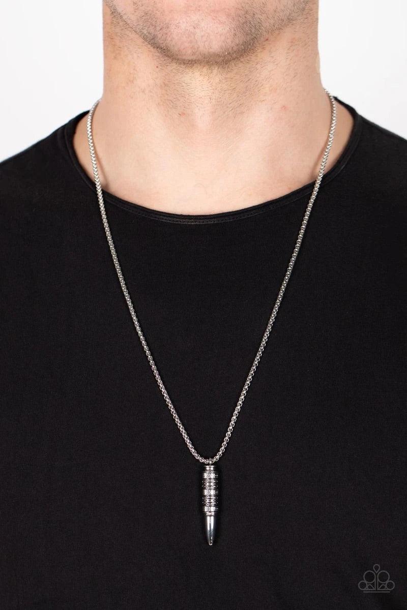 Paparazzi Accessories Highland Hunter - Silver A tribal-inspired motif wraps around a silver bullet-shaped pendant at the end of a round silver box chain resulting in a striking ancestral adornment below the collar. Features an adjustable clasp closure. S