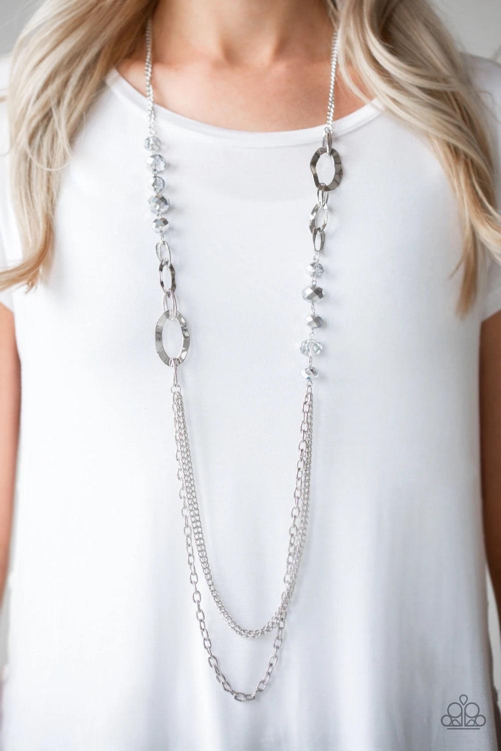 Paparazzi Accessories Modern Girl Glam - Silver Dipped in metallic shimmer, a collection of smoky crystal-like beads and hammered silver frames give way to layers of mismatched silver chains for a modern look. Features an adjustable clasp closure. Sold as