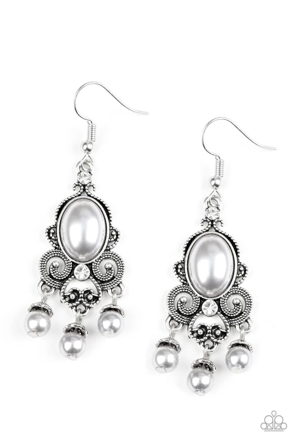 Paparazzi Accessories I Better Get GLOWING - Silver Dotted silver filigree spins around a pearly silver bead and dainty white rhinestones, coalescing into a regal frame. A pearly fringe swings from the bottom of the frame for a refined finish. Earring att