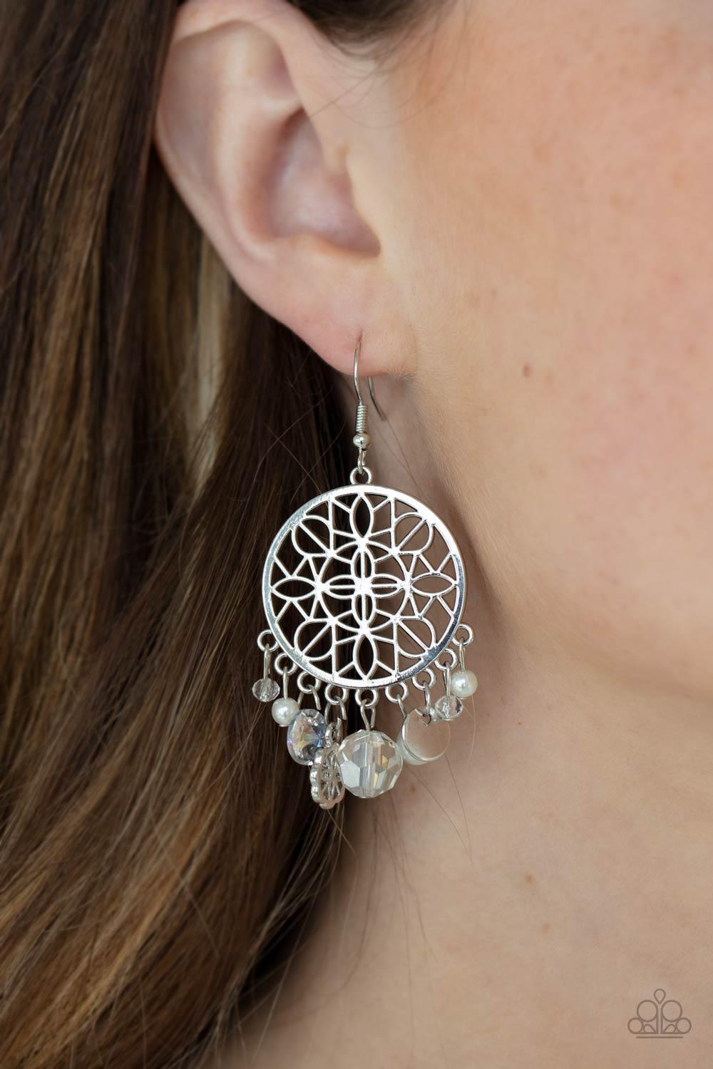 Paparazzi Accessories Garden Dreamcatcher - White Floral filigree blooms inside a circular silver frame as a mismatched assortment of a hammered silver disc, dainty pearls, sparkly crystal-like beads, and a matching floral filigree charm dance from the bo