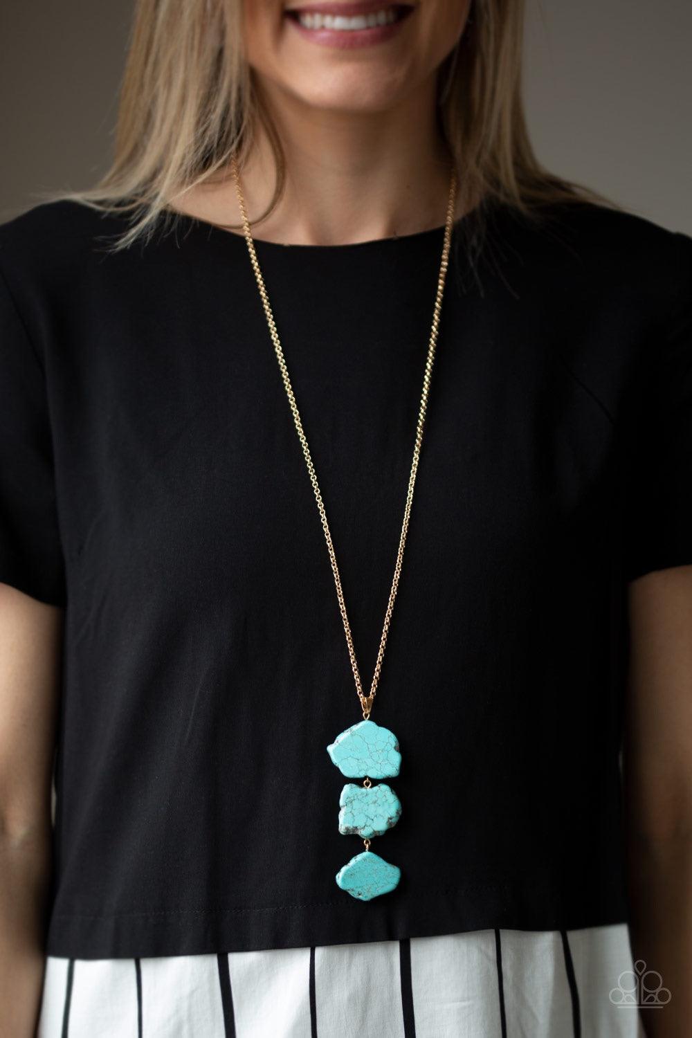 Paparazzi Accessories On The ROAM Again - Gold As if chipped off a cliff, pieces of turquoise rock link at the bottom of a lengthened gold chain for an earthy look. As the stone elements in this piece are natural, some color variation is normal. Features